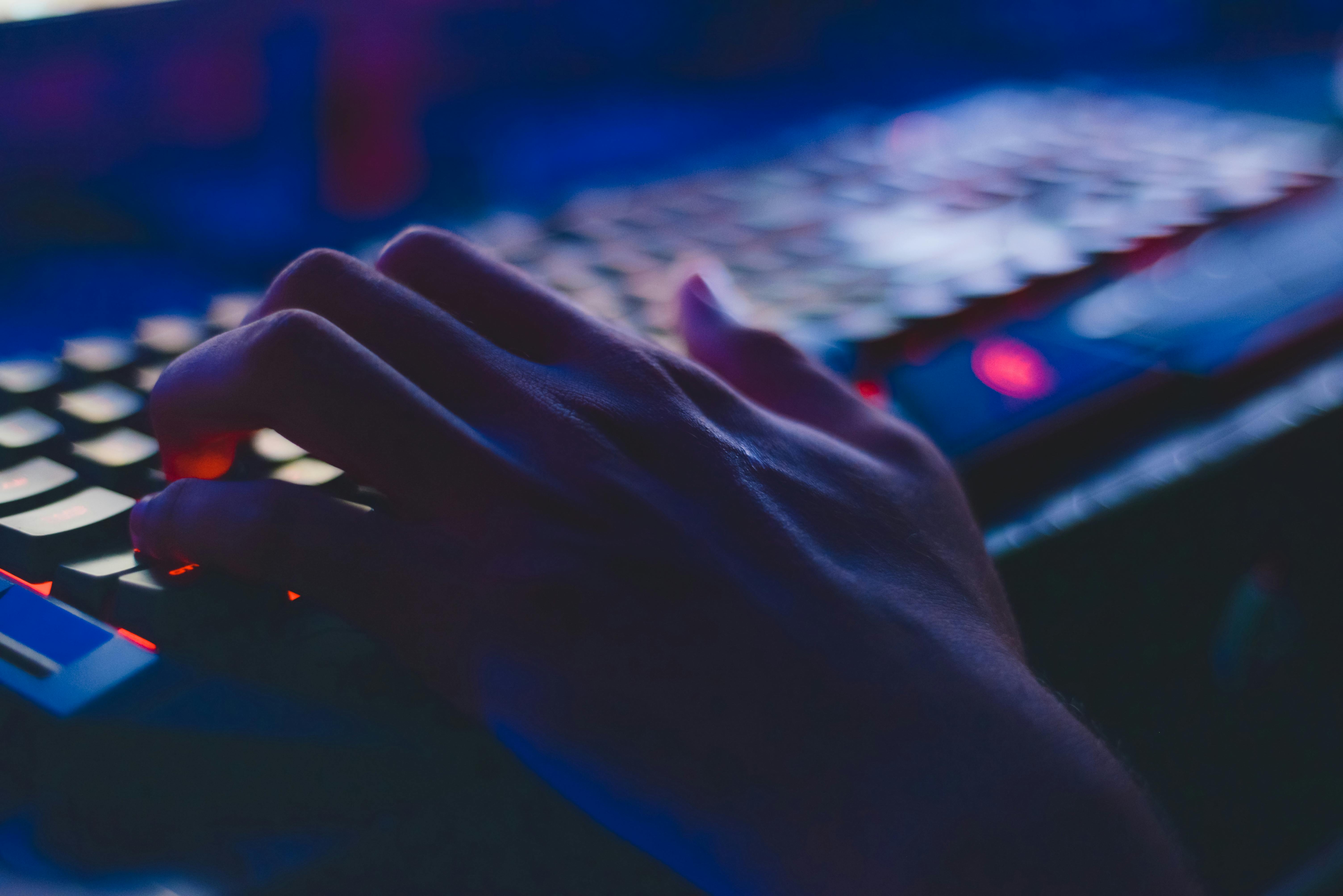 Photo of person typing on computer keyboard